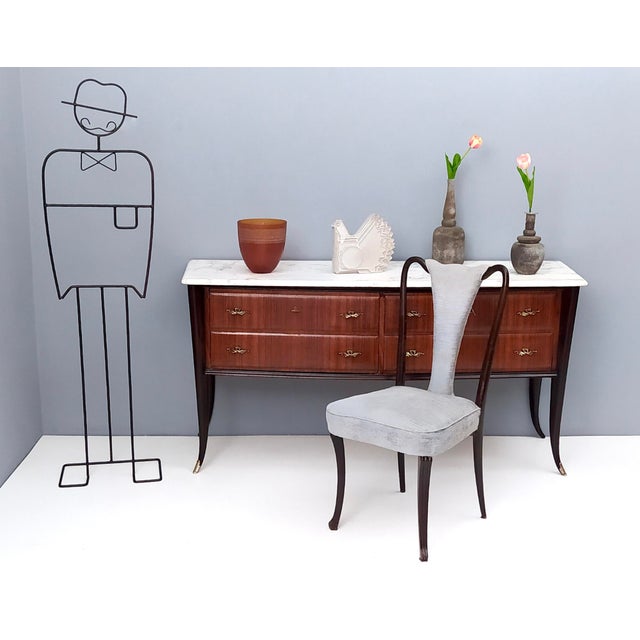 Made in Italy, 1950s. This dresser is made in lacquered Canaletto walnut. It features solid beech legs, solid durmast...