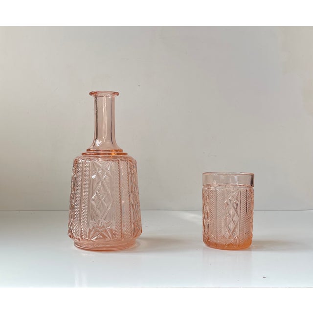 I drink on my own' decanter in cast pink glass. Made by Brockwitz in Germany during the 1920s. It features its original...
