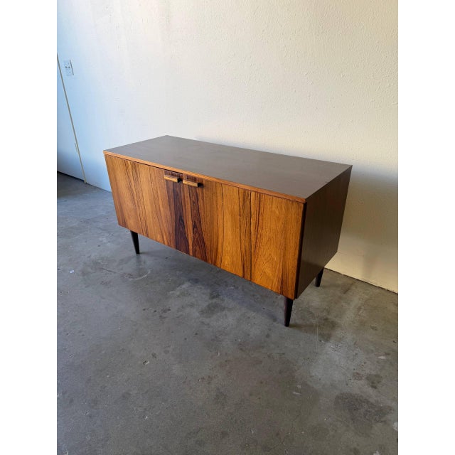 Beautiful vintage Danish sideboard crafted in richly grained rosewood, dating to the 1960s. This piece features striking...