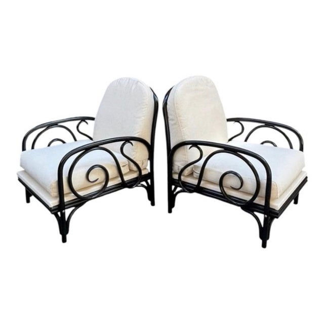Italian armchairs, circa 1950, made of bent and ebonized beech wood. The curves and spirals along the sides are...