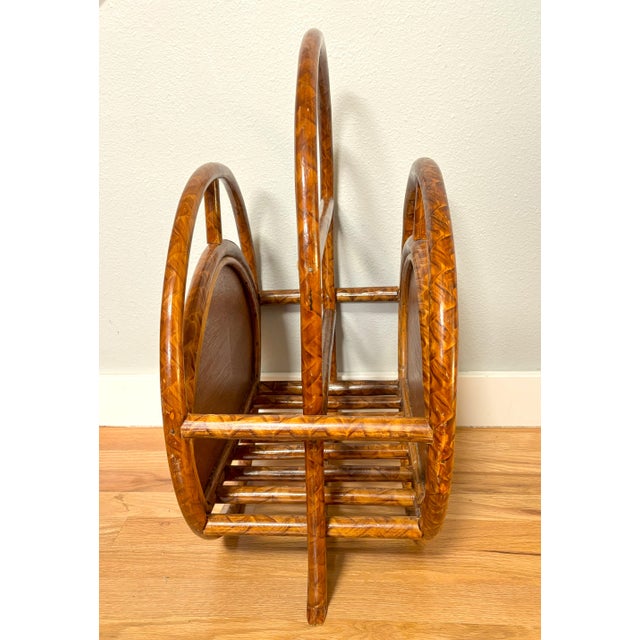 This rattan and woven cane magazine rack/book holder, which dates to the 1960s/1970s, is in excellent vintage condition....