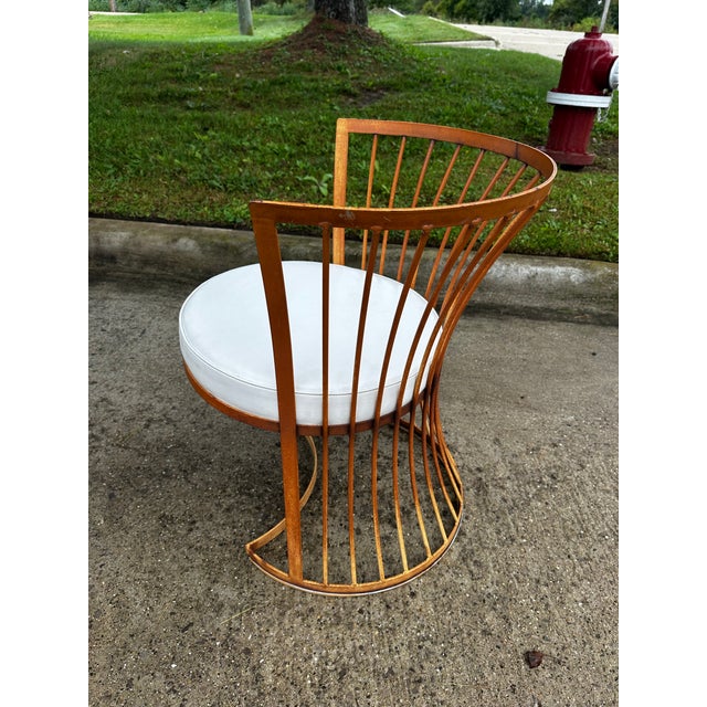 Attributed to Russell Woodard MCM barrel back wrought iron chairs in original condition. This specific style features a...
