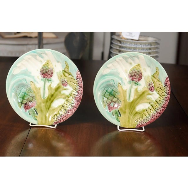 A pair of French late 19th century majolica asparagus and artichoke plates from Lunéville. Born in the Lorraine area of...