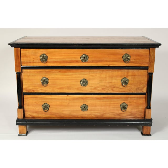 Biedermeier / Empire birch chest of drawers with ebonized details, circa 1830. With a rectangular birch top with a...