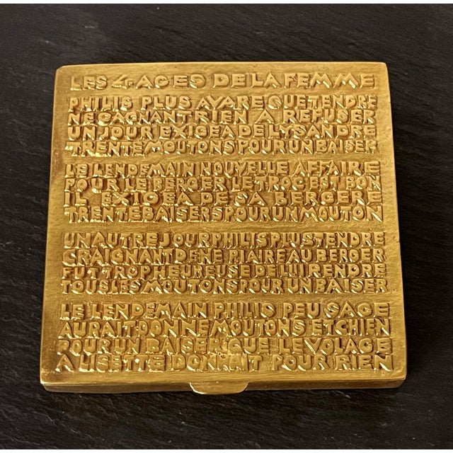A gilt bronze poudrier box with cast poem on surface by Parisian art jeweler Line Vautrin (1913-1997) circa 1940s. The...
