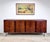 A stunning mid century modern rosewood credenza on chrome steel legs circa 1970’s. Features beautifully figured wood grain...