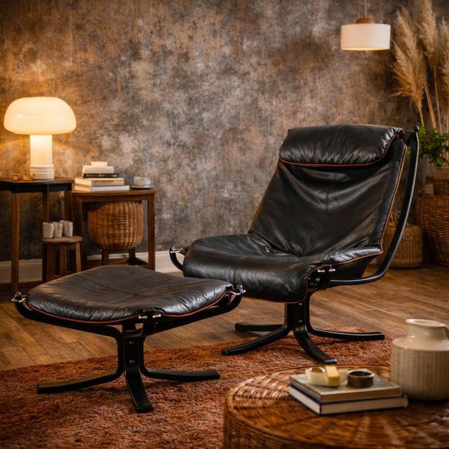 Viking' armchair with footrest made of curved plywood stained walnut, foam padding, leather upholstery. This piece is...