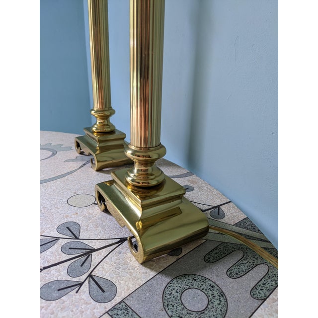 Pair of late 20th century art deco style lamps featuring a Corinthian-style fluted column design and scroll base.