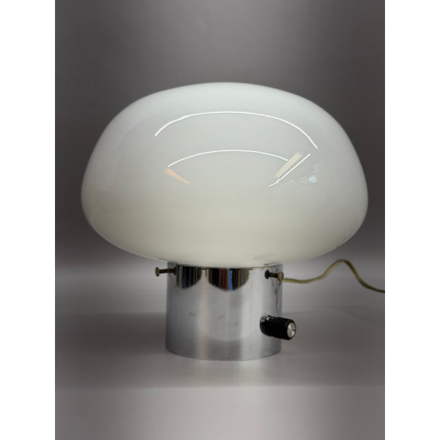 Fine stylish mushroom table lamp with a polished chrome base and milk glass mushroom shaped shade. Black dimmer switch....
