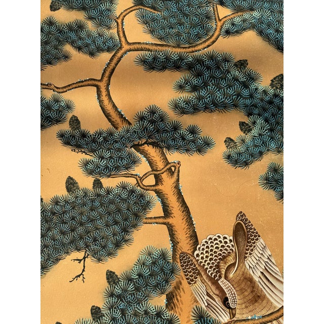 Luxury hand painted gold leaf wallpaper sample featuring an elegant crane and pine tree composition inspired by...