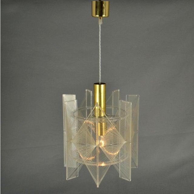 Sculptural small lamp in cone shape of clear acrylic glass and clear transparent wire accompanied brass internal fittings...