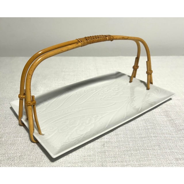 Stylish and functional, this MCM Neiman Marcus tray blends sleek Japanese porcelain with a warm bamboo handle for the...