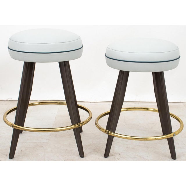 Set of Five French Mid-Century Modern Stools, 1950s, aluminum frames with brass ring foot rests and pale blue leather...
