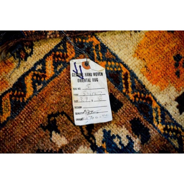 A unique late 20th century Shiraz rug with a beautiful all-over light and dark indigo, gold and brown floral pattern on an...
