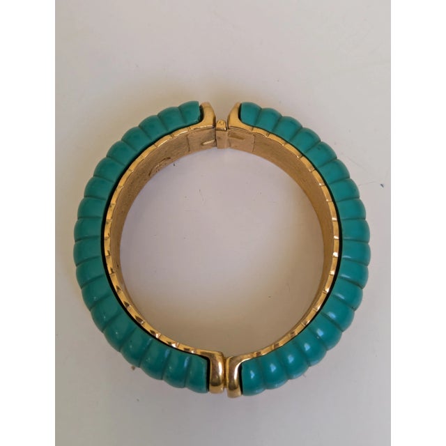 Kenneth Jay Lane Bangle from the 1980's in teal and gold tone. The clasp is a spring clasp. Good for dressy to casual...