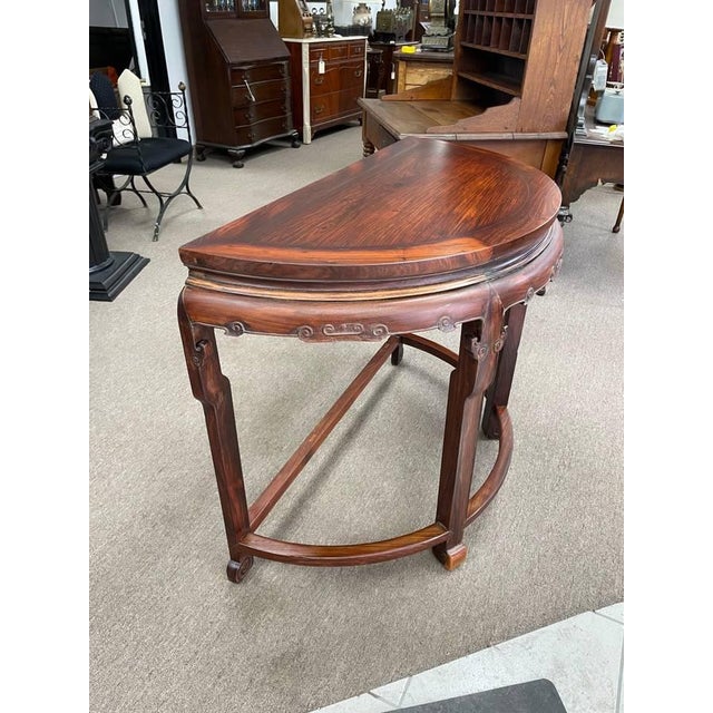 Up for sale is a vintage semi circle console table made from solid rosewood. The table has a nice dark finish that shows...