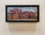 This oil on board painting captures a vibrant industrial scene, showcasing the architectural details of Burnham Yards with...