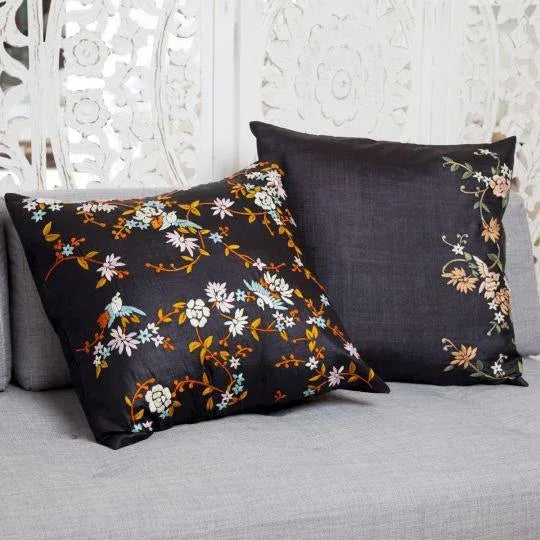 With vibrant orange, blue, pink and cream threads interlaced on a bold black backdrop, the birds and blossoms...