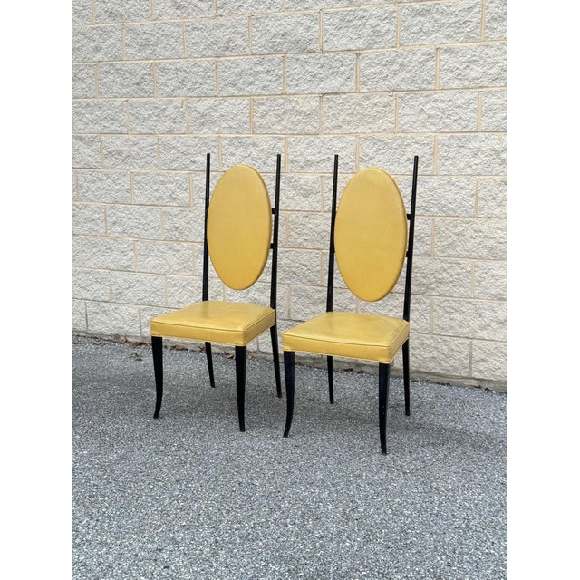 Pair of Italian modern chairs constructed with black ebonized wooden frames and upholstered in yellow leather. Each chair...