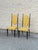 Pair of Italian modern chairs constructed with black ebonized wooden frames and upholstered in yellow leather. Each chair...