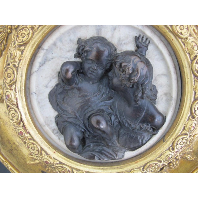 Marble relief circular Carrera marble plaque with wood composite depicting two cherubs or putti children originally...