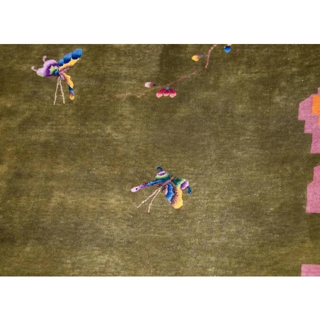 A remarkable early 20th century Chinese Art Deco rug with a brilliant chartreuse green field surrounded by a wide gold and...