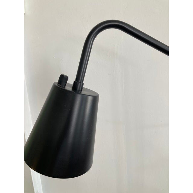 Modern Floor lamp in the style of French Designer Jaques Adnet. Nice Black and Brass color and finish combinations....