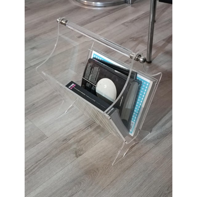 Beautiful vintage magazine rack. France, 1980s. Clear acrylic glass frame with decorative engraved lines. Chrome-plated...