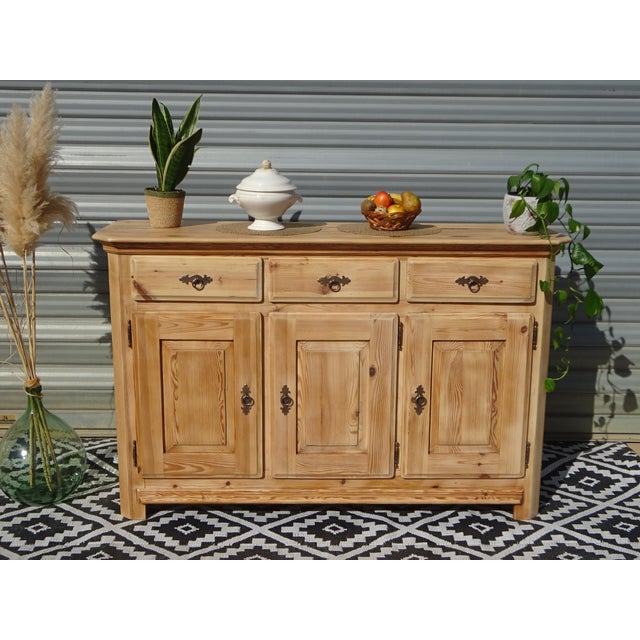 Three-door, three-drawer sideboard made entirely of solid pine. This sideboard features clean, straight lines and a...