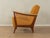 A wonderful armchair from the 1950s. High-quality beech frame with rattan weaving on the sides. The original spring core...