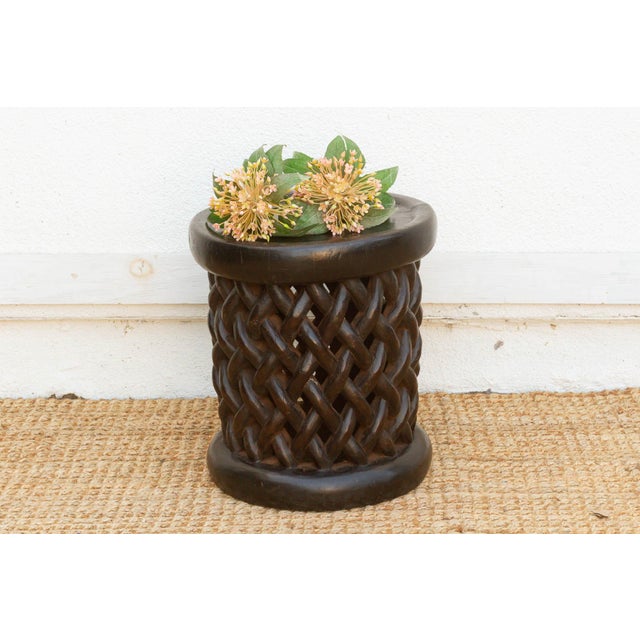 This charming 16” African stool is an authentic example of the celebrated woodcarving traditions of the Bamileke people...