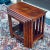 Vintage nest of four solid rosewood tables featuring brass marquetry and corner detail. The individual tables measure...