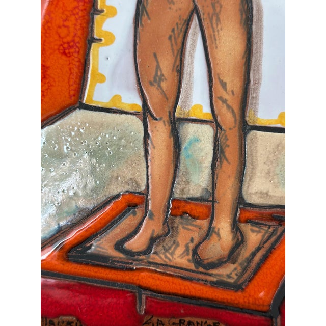 A striking and richly glazed ceramic tile panel titled “L’Homme au Mouton” (The Man with the Lamb), created in Vallauris...