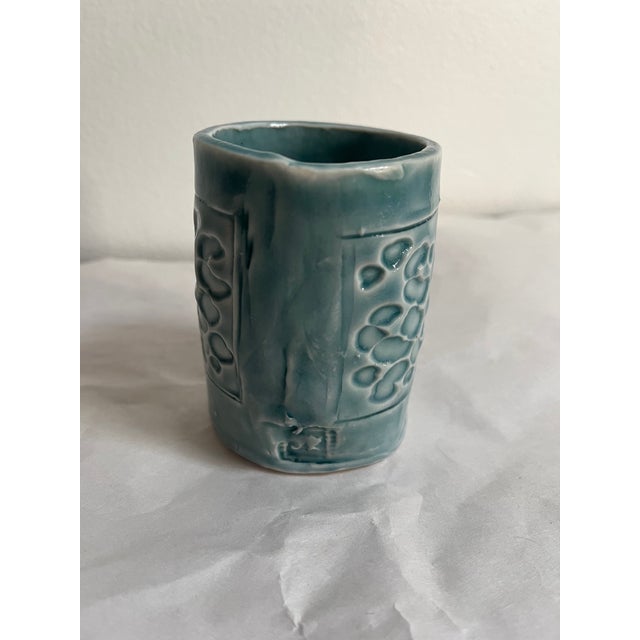 Small ceramic planter (no drainage holes) with light blue glaze and textured pattern on surface. Irregular, handbuilt...