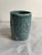 Small ceramic planter (no drainage holes) with light blue glaze and textured pattern on surface. Irregular, handbuilt...