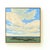 The artwork captures a vast landscape under a sweeping sky, where soft, billowing clouds stretch across a serene blue...