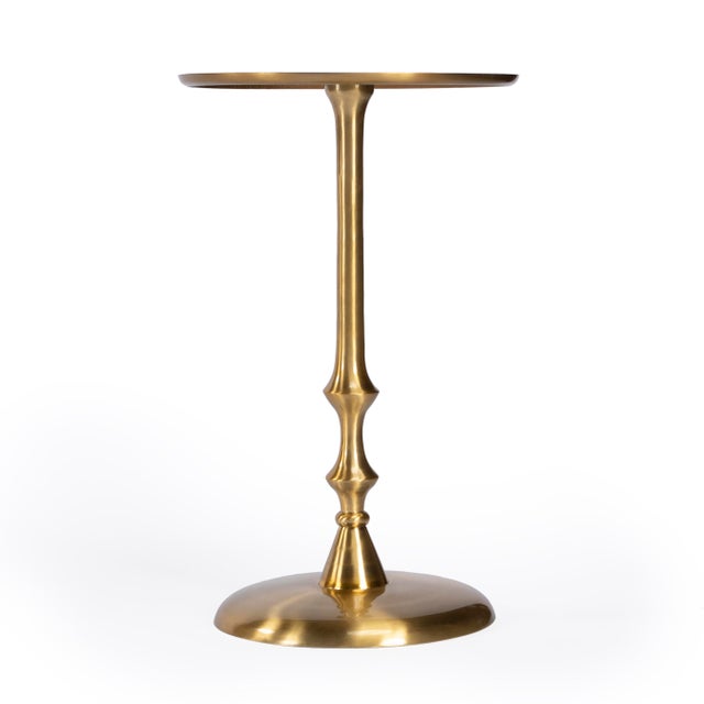 Crafted from aluminum, this shiny gold- toned table features an exquisitely turned base and pedestal. It's modern and...