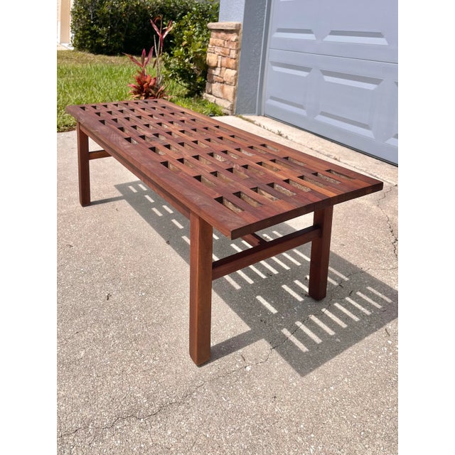 Petite Teak Slotted Coffee Table. This is a classic, modern design from the 1970s. A squared-off motif at edges and...