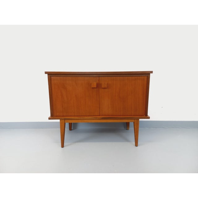 Small vintage Scandinavian-style low sideboard from the 1960s, made of teak, with splayed legs, charming original square...