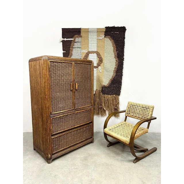 This stunning vintage rattan/bamboo cabinet exudes pure Bohemian charm. The combination of woven rattan and beautiful...