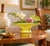 Unusual Mid-Century Modern ceramic footed bowl featuring a vibrant chartreuse yellow exterior, contrasting green interior,...
