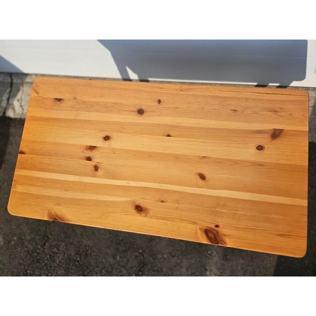 Swedish pine side table. The piece is not marked. Dimensions: 18"H x 30"W x 17"D. Condition: In good condition with a few...