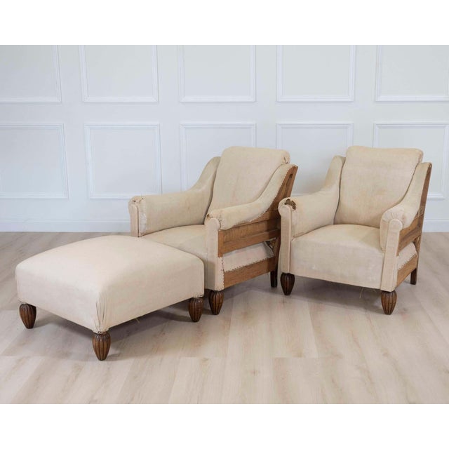 Stylish pair of Art Deco club chairs accompanied by a matching stool, dating from the early 20th century. The frames...