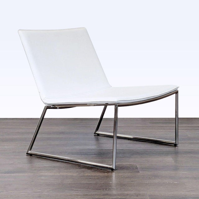 This CB2 lounge chair features a clean, modern design with a white seat and sleek chrome frame. Comfortable and stylish,...