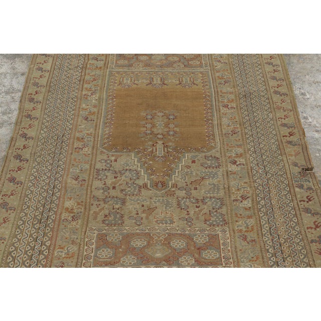 Hand-knotted in wool, this 4x6 Vintage Turkish Anatolian Prayer Rug, circa 1950–1959, presents a soft ivory and golden...