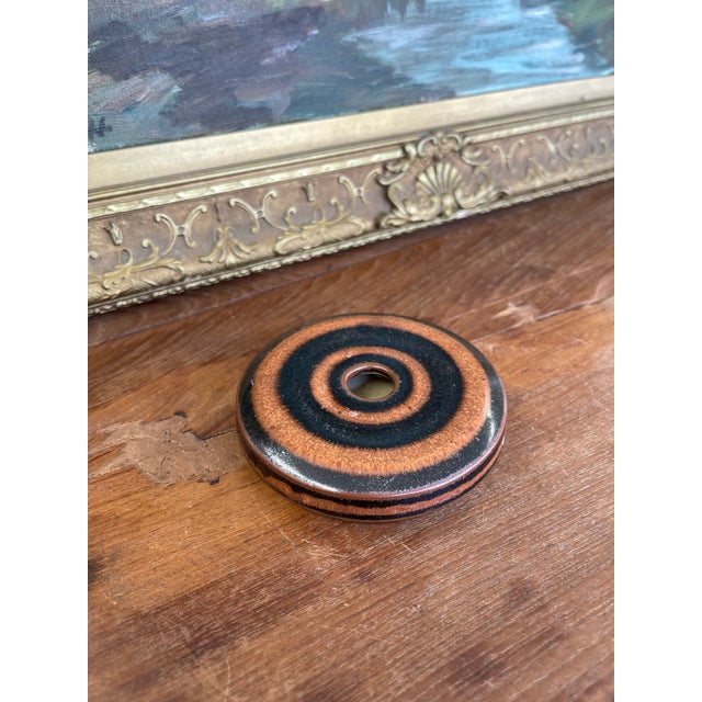 A distinctive studio pottery donut vase by ceramic artist Hank Greer, featuring a low-profile, circular form with a...