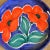 An Italian pottery tray with red flower design on a blue background by Bellini.