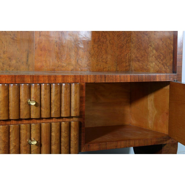 An elegant Italian Art Deco sideboard dating from the 1940s, distinguished by its sophisticated combination of walnut...