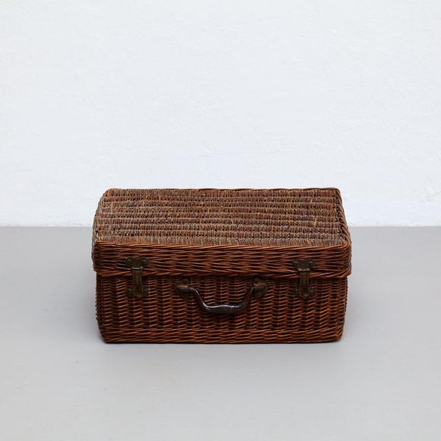 Mid-Century Modern French rattan basket. In original condition with minor wear consistent of age and use, preserving a...