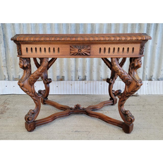Figural carved Italian Renaissance Revival end table with four winged female griffins and black marble top. Circa. 1930's....